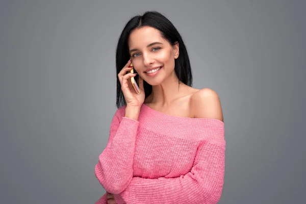 Friendly woman speaking on phone