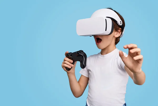 Amazed kid in VR headset playing game — Stock Photo, Image