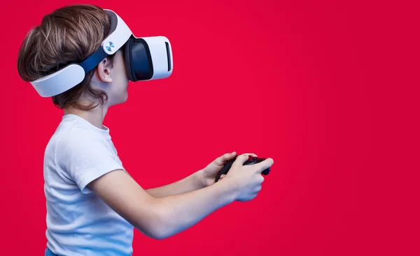 Playful boy in VR goggles and with gamepad — Stock Photo, Image