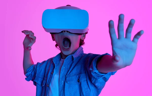 Kid exploring virtual reality in neon lights — Stock Photo, Image