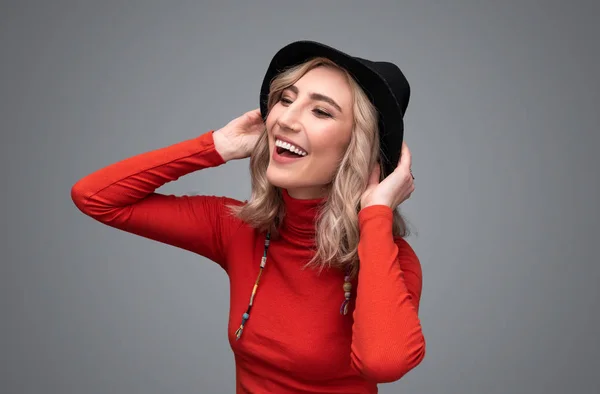 Mujer alegre tocando sombrero — Foto de Stock