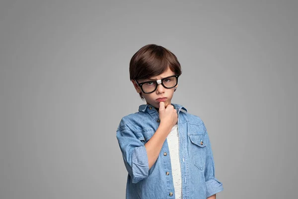 Serious boy in glasses looking at camera — Stock Photo, Image