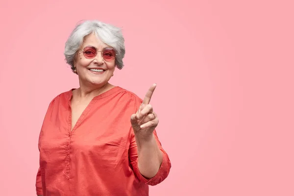 Cheerful elderly lady interacting with invisible screen — Stock Photo, Image