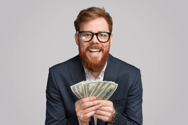 Cheerful bearded man with money