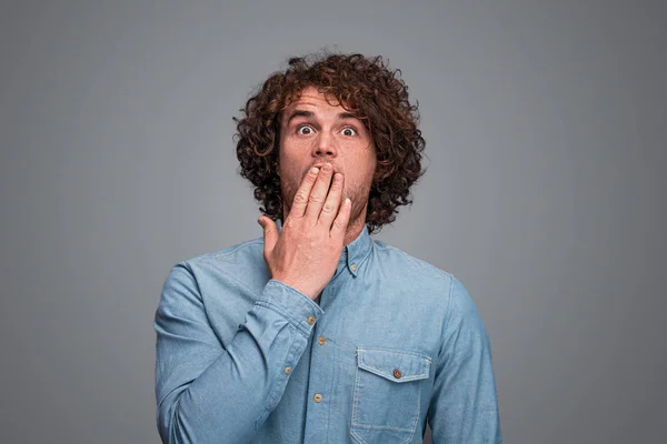 Shocked male covering mouth — Stock Photo, Image