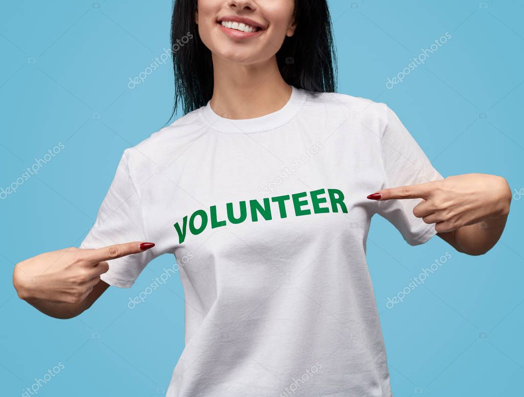 Crop volunteer pointing at T-shirt