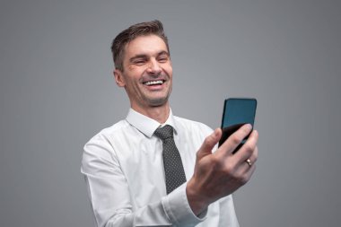 Akıllı telefon kullanarak gülüyor işadamı