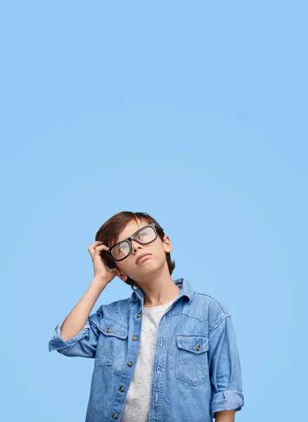 Little boy scratching head in contemplations — Stock Photo, Image