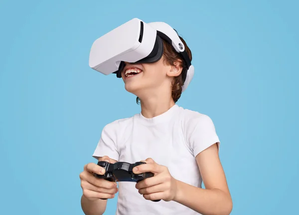 Cheerful boy playing videogame in VR goggles — Stock Photo, Image
