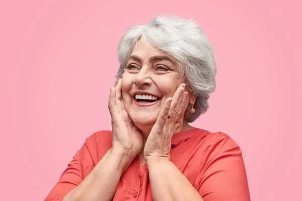 Excited elderly woman looking away — Stock Photo, Image