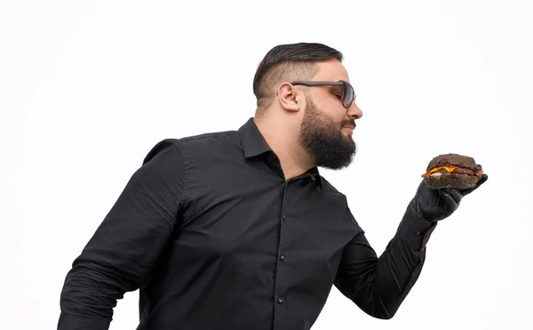 Stylish cook smelling burger — Stock Photo, Image