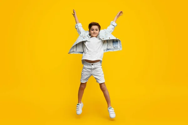 Мальчик поднимает руки и прыгает — стоковое фото