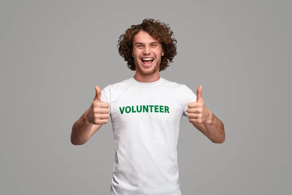 Cheerful volunteer gesturing thumb up — Stock Photo, Image
