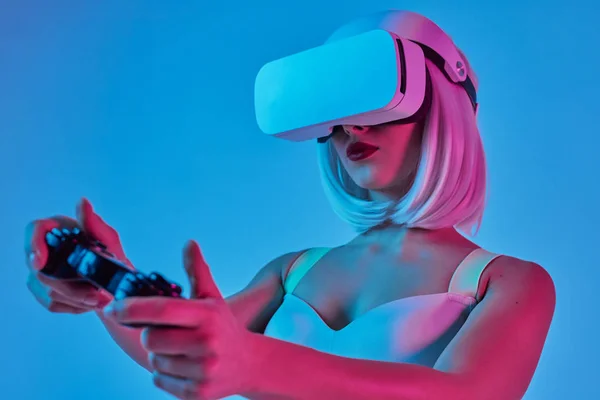 Young lady in VR helmet playing video game — 스톡 사진