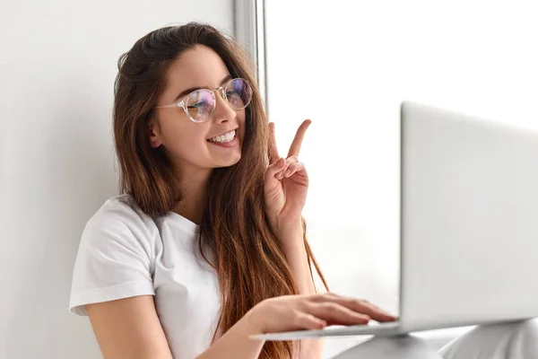 Cheerful female teenager having video conference with friend — Stock Photo, Image