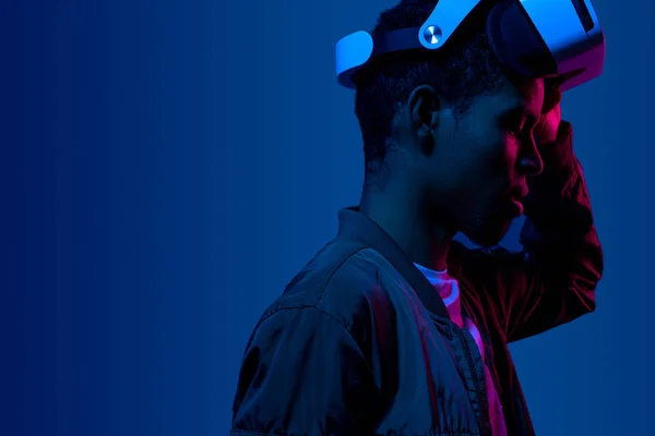 Futuristic black male in VR helmet — Stock Photo, Image