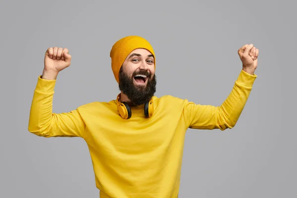 Excited hipster dancing with clenched fists — Stock Photo, Image