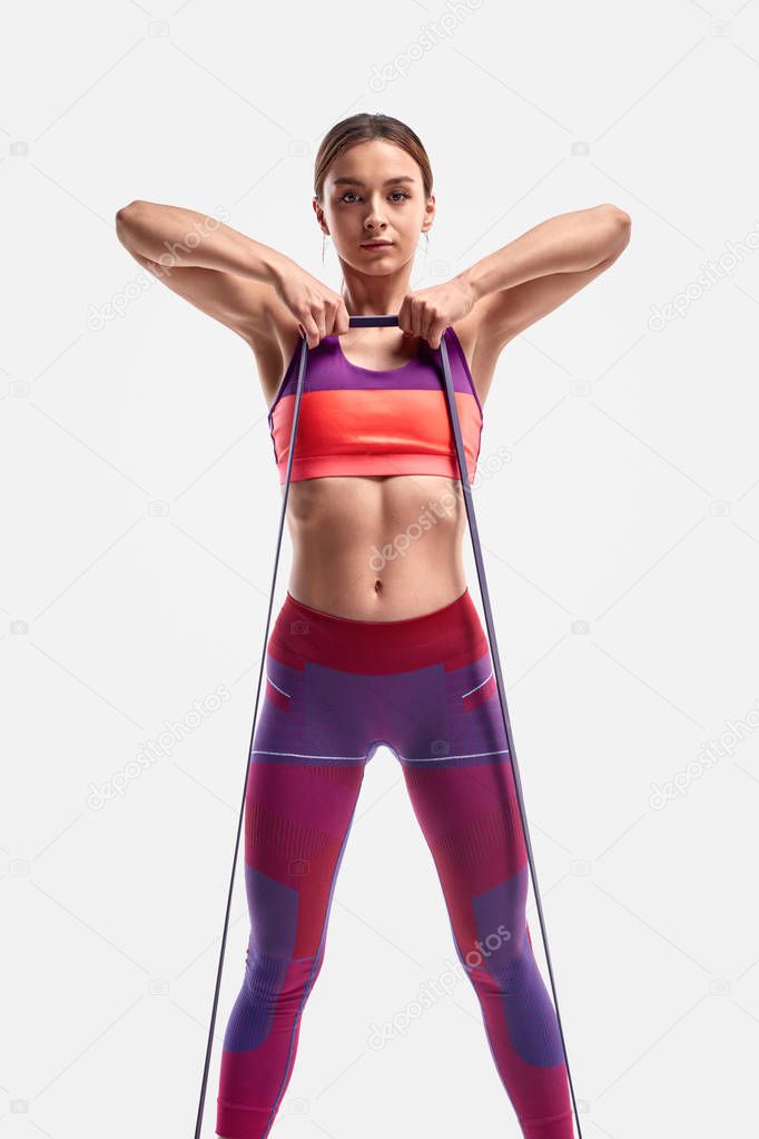 Sportswoman exercising with resistance band