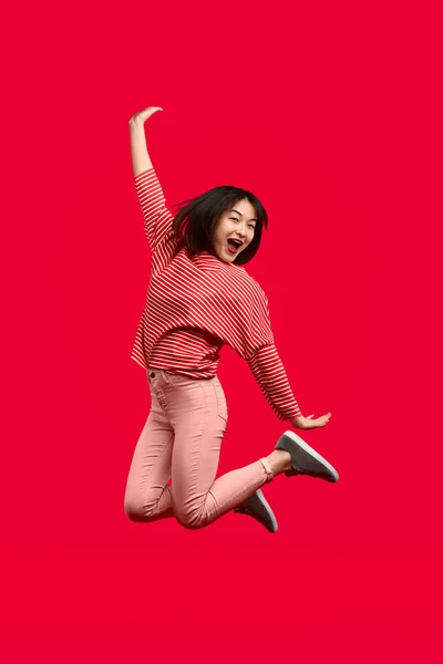 Cheerful Asian woman leaping up — Stock Photo, Image