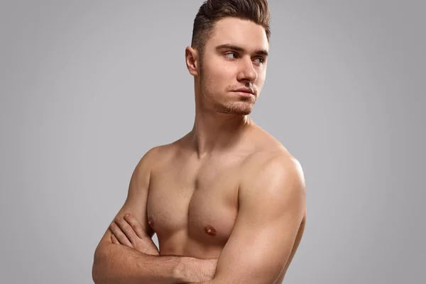 Confident shirtless man looking over shoulder — Stock Photo, Image