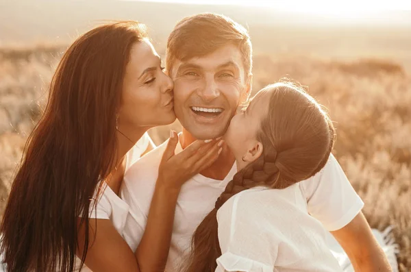 Happy casual family cuddling together at countryside — Stock Photo, Image