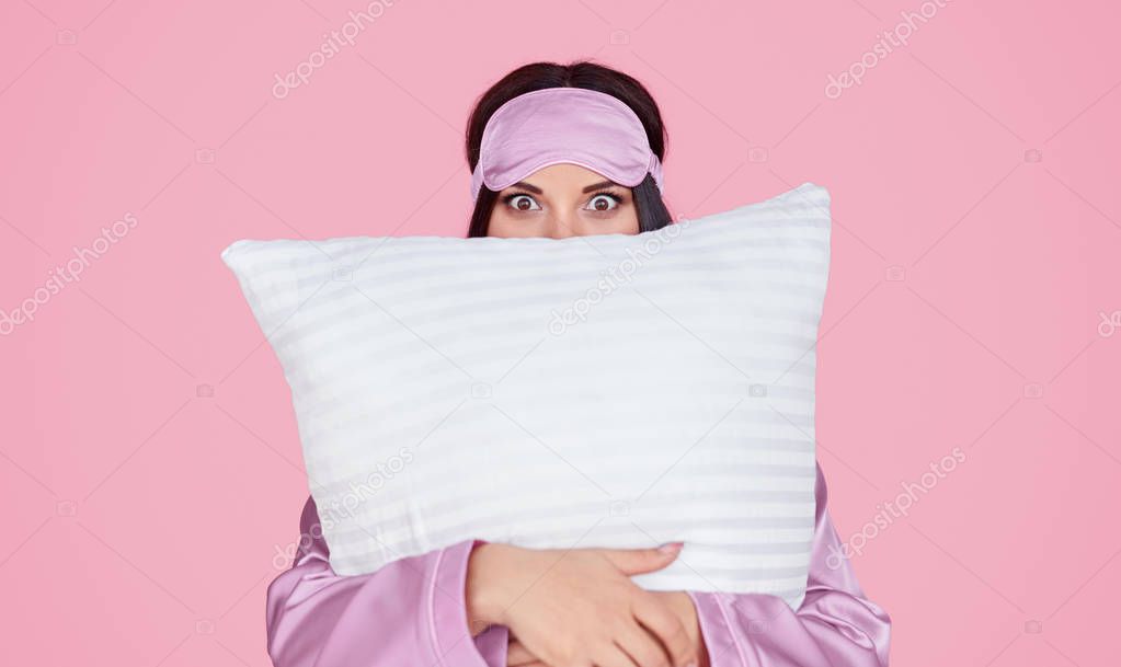 Young woman hugging soft pillow