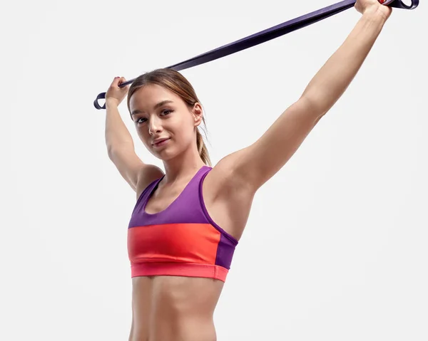 Young athlete exercising with resistance band — Stock Photo, Image