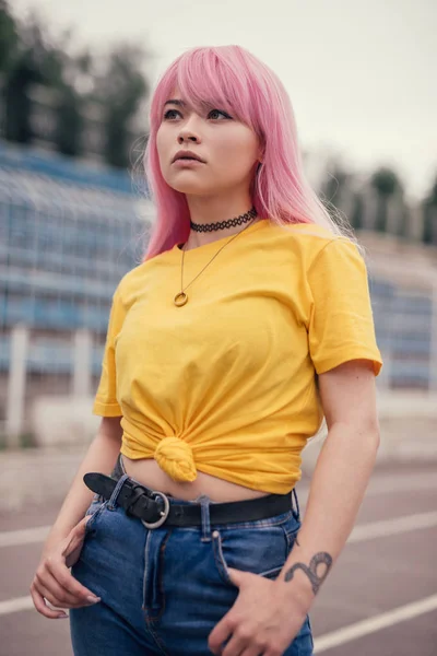 Dreamy ethnic teenager on city stadium — Stock Photo, Image