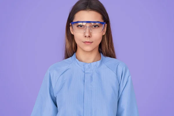 Smart woman in lab goggles and coat — Stock Photo, Image