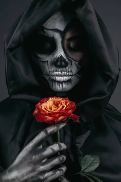 Terrifying female with skull face and red flower — Stock Photo, Image