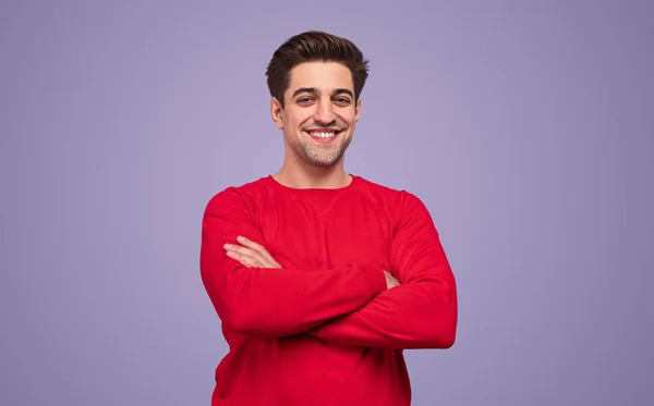 Cheerful man in red sweater with folded hand — Stockfoto