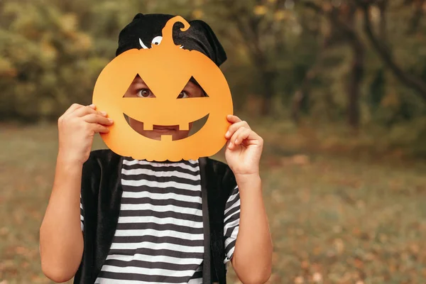 Funny kid standing with Halloween mask on nature background — Stock Photo, Image