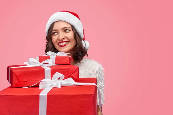 Cheerful woman with stack of New Year gifts — Stockfoto