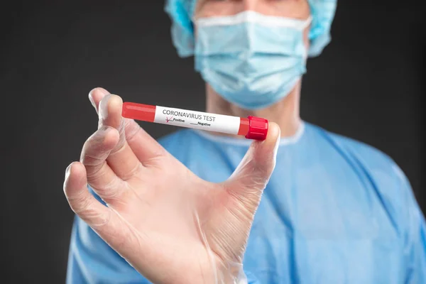 Crop doctor showing coronavirus test tube — Stock Photo, Image