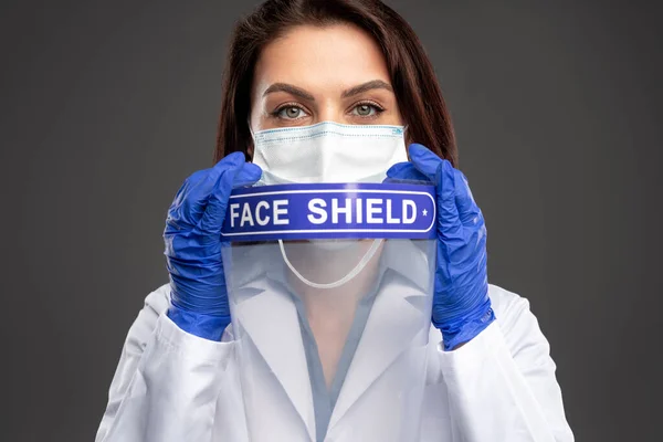 Female doctor with face shield