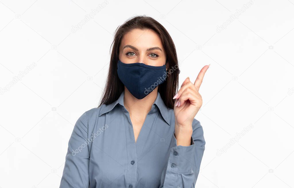 Woman in protective mask pointing up