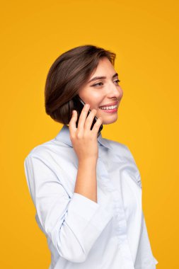 Neşeli kadın akıllı telefondan konuşuyor.