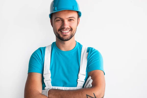 Trabajador masculino positivo en casco mirando a la cámara — Foto de Stock