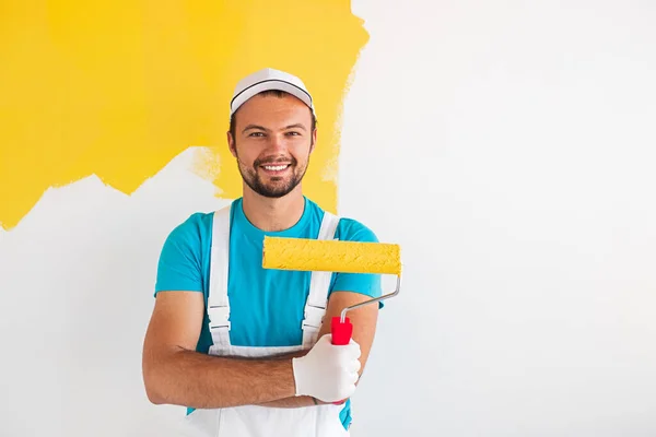 Positive painter with paint roller — Stock Photo, Image