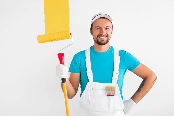Positive professional painter with roller — Stock Photo, Image