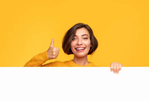 Happy woman approving blank banner — Stock Photo, Image