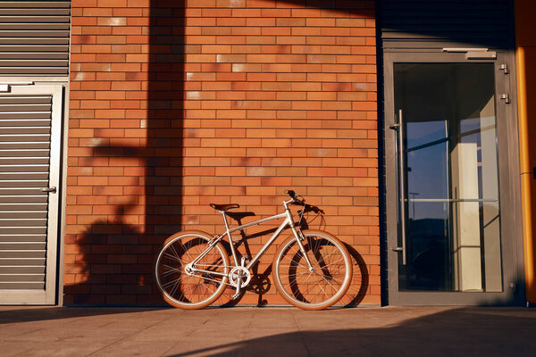 Bicycle parked near brick building