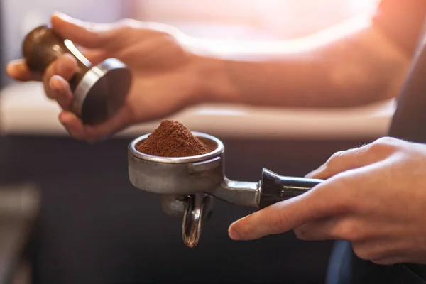 Close-up of hand Barista cafe making coffee with manual presses ground  coffee using a tamper at the coffee shop 27393656 Stock Photo at Vecteezy