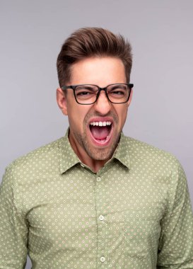 Öfkeli adam kameraya bağırıyor.