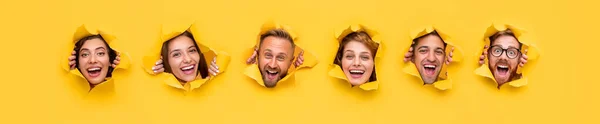 Excited people tearing yellow paper — Stock Photo, Image