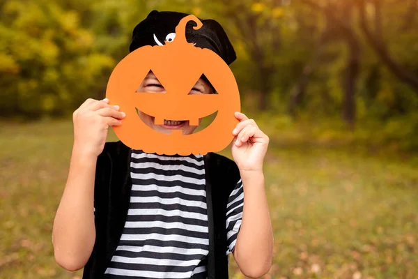 Funny kid standing with Halloween mask on nature background — Stock Photo, Image