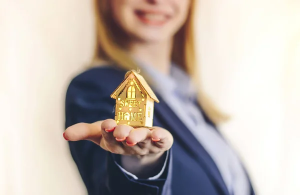 Business woman holding small house on the hand