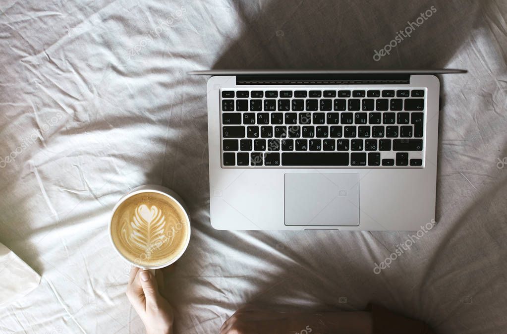 Morning with laptop in a white bed