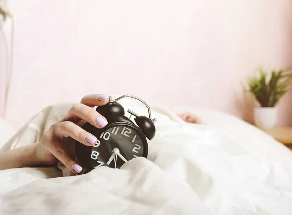 Жіноча Рука Білому Ліжку Тримає Будильник Вранці — стокове фото