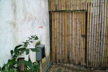 Bambu duvara el yapımı bir bambu kapı